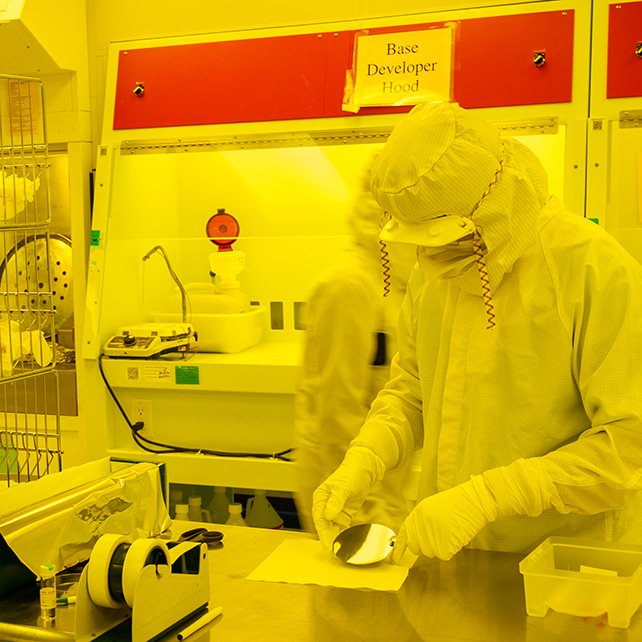 student in a yellow cleanroom