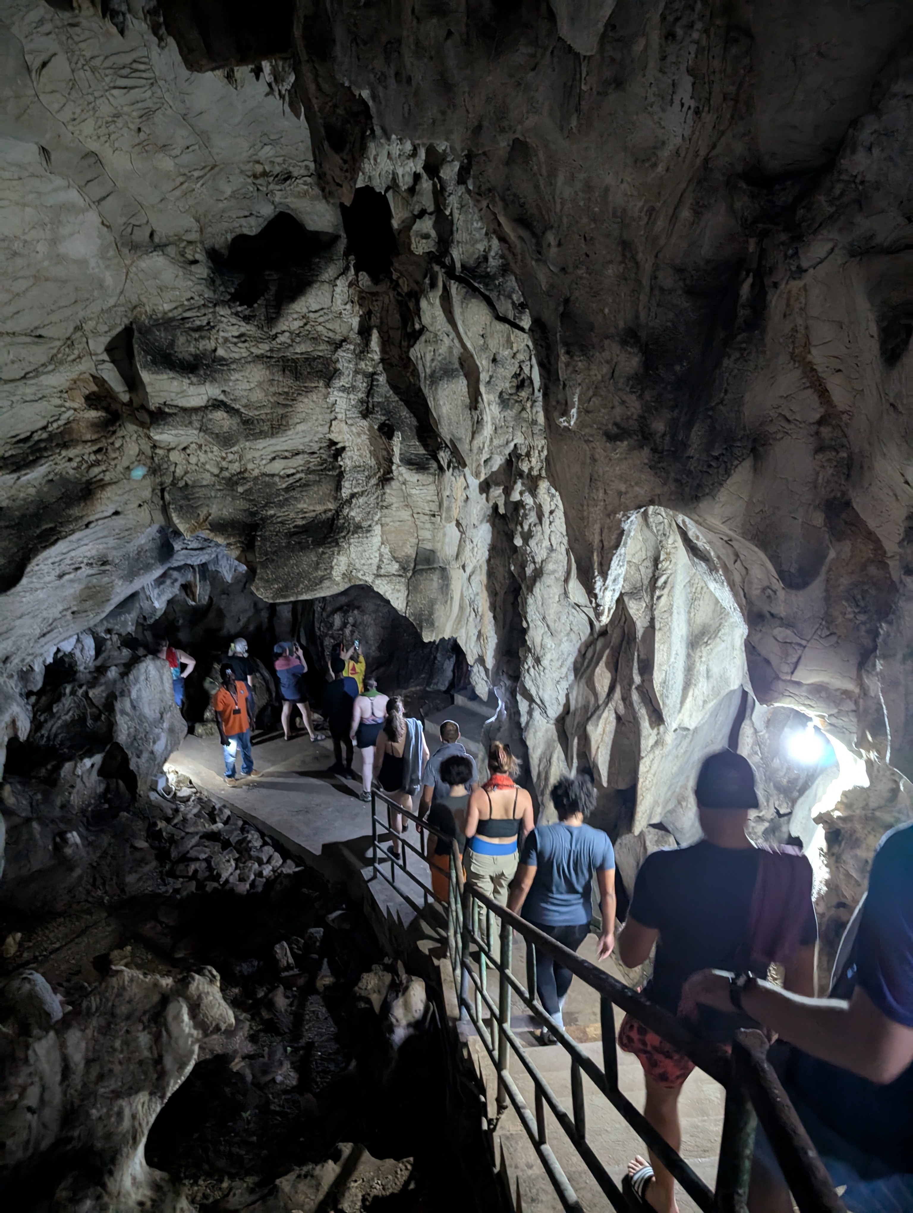 people walking through dark caves