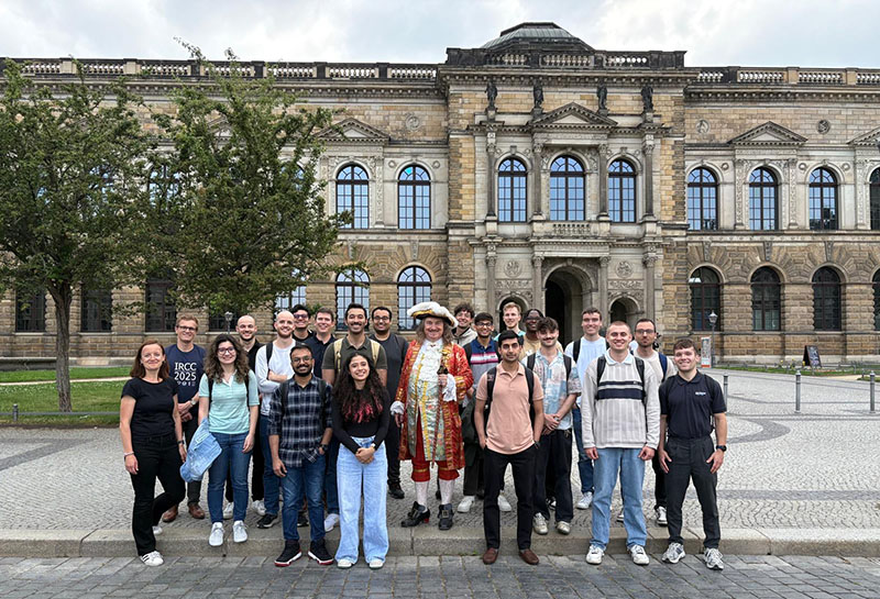 Large group of students gather in front of an old building in Dresden, Germany.