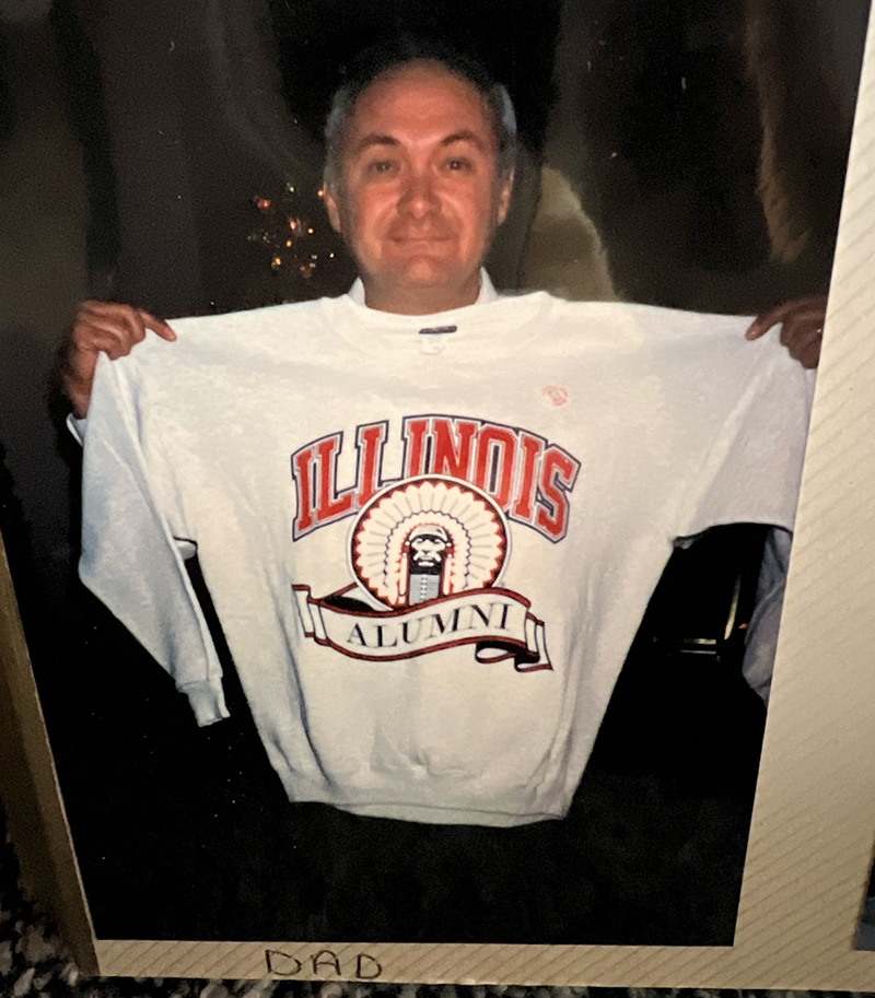 Donald Janka holding an Illinois sweatshirt