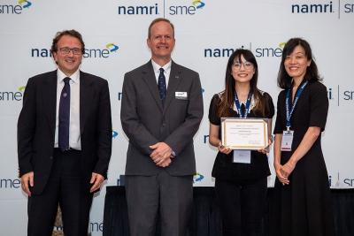 Ping-Ju Chen, second from right, receiving the student award.