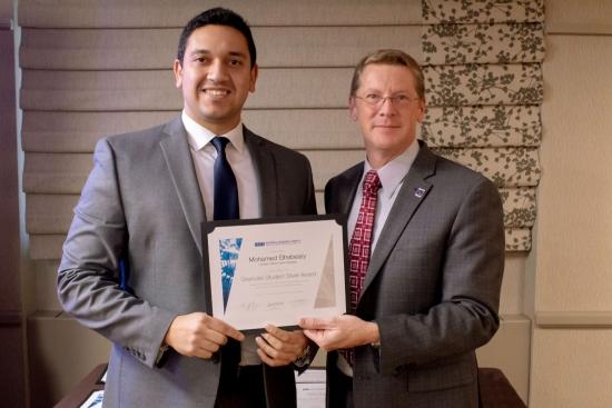 Mohamed Elhebeary with the president of Materials Research Society, Sean J. Hearne.