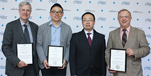AIST's Yufeng Wang (center) presented the award to Thomas, Chen, and Bentsman.