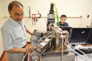 Kapoor and graduate student James Zhu work on the development of a testbed to manufacture surgical-grade knife blades from bulk metallic glass using a hybrid thermoplastic forming process. The process involves sequential micro-molding and micro-drawing operations to produce multi-facet/curvilinear geometries. Preliminary tests have shown that cutting edge radii of less than 20 nm, an average surface finish of 21.6 nm, and edge straightness deviations of less than 5 Î¼m RMS could be achieved with the manufacturing testbed. 