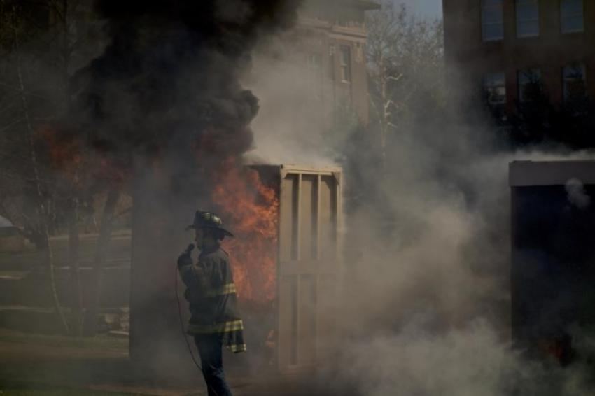 A student with the Illini Society for Fire Engineers speaks during the smoke detector demonstration held on the quad.