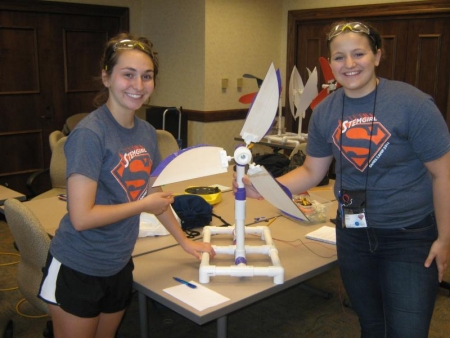 Pakeltis, right, shows off her wind turbine project while attending GBAM camp in 2014.