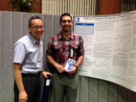 Kyle Mackay (right) with his Outstanding Poster Award. (Photo courtesy of Lawrence Livermore National Lab)