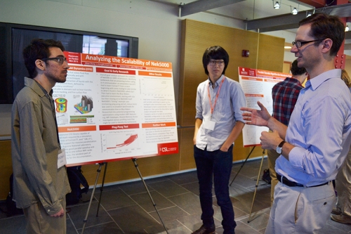 Associate Professor Matt West (right) talks to Passionate on Parallel participants Michael Zoller (left) and Oliver Chang during the poster session.