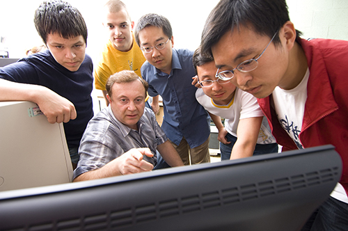 Professor Joseph Bentsman (center) with a few of his students who contributed to the research recognized by the ISA POWID.