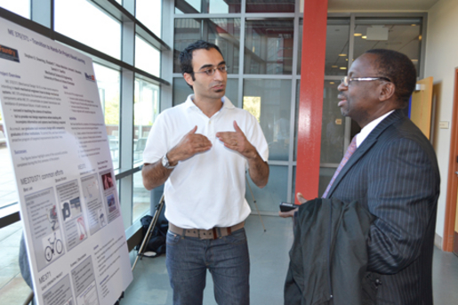 MechSE assistant professor Sameh Tawfick explains the particulars of ME 370 and 371 to Illinois Provost Ilesanmi Adesida.