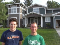 Drew Coverdill and Ken Heinz stand outside the refurbished Montgomery home. 