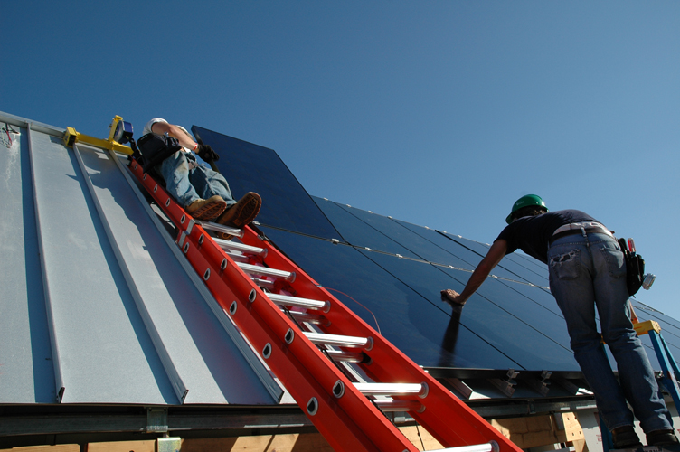 Students instralling a solar panel