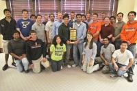 MechSE students pose with the Spirit of Illini Engineering trophy.
