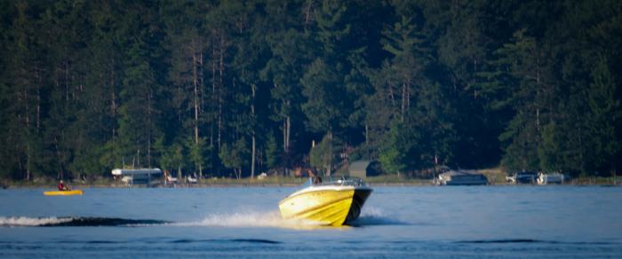 Deep-V hull planing in calm water on Higgins Lake, MI. Photo by Taylor Tucker. 
