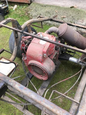 The engine bolts to the two center rails of the frame as well as the transaxle housing.