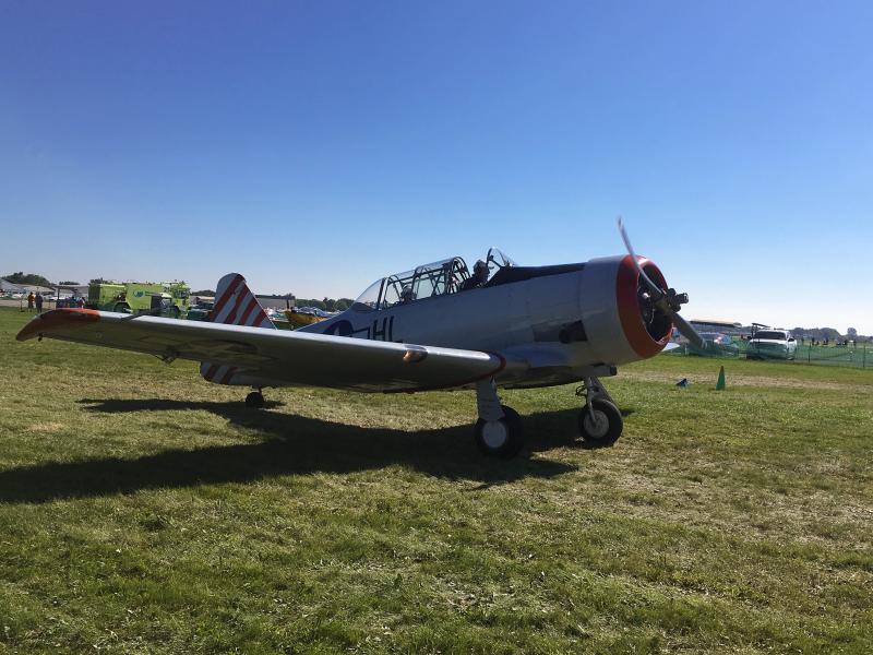 A T-28 Texan taxies to parking in Warbird Alley.