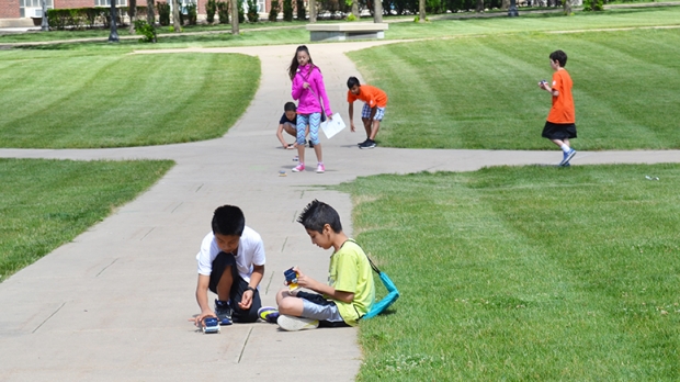 Students from the Urbana Middle School Summer Math Academy met up with volunteers from ENVISION and POETS to take advantage of some summer weather on the Bardeen Quad on Tuesday.