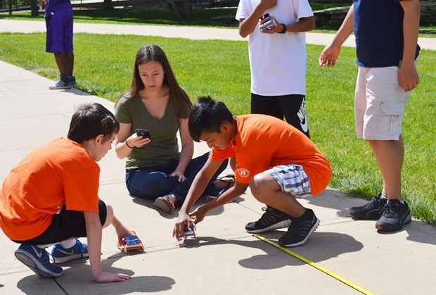 Although the sun hid from time to time, and there were some incidents of loose wheels, the sun came out long enough to power their cars and there were plenty of helping hands to walk them through their worksheets.