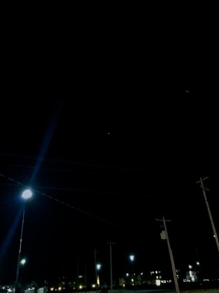 A view of Jupiter, resembling a distant star, outside the Beckman Institute.