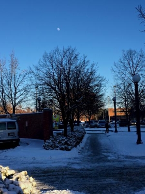 View of the afternoon moonrise from outside Grainger.