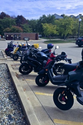 Variety of mopeds and motorcyles outside Talbot Lab.