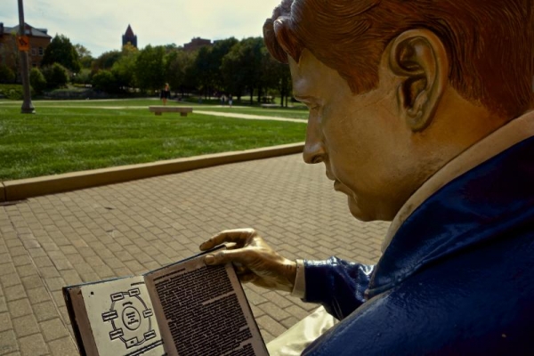 The Engineer, reading outside of Grainger Library.