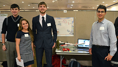 Ian Weivoda (MechSE), Sarah Cunningham (ECE), Josef Sabuda (MechSE), Peter Lordanov (CS), and Tyler Hartman (Aero, not pictured) pose with the innovation they called the Delivery Plane.