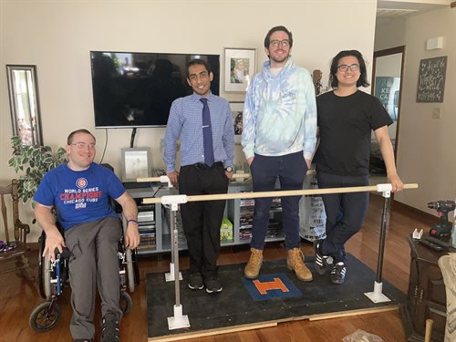 The team with their final product. The two rods allow the client to support himself while the platform offers stability. Achieving their initial goals, the device is easy to assemble and transport.