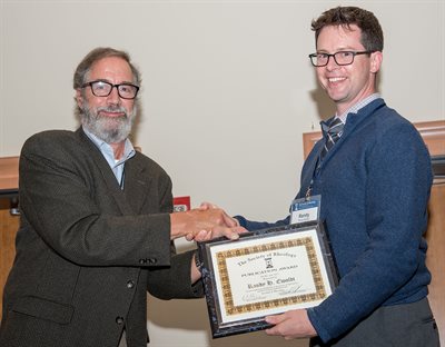 Ewoldt (right) receives the award from the editor of The Journal of Rheology, Professor Ralph Colby.