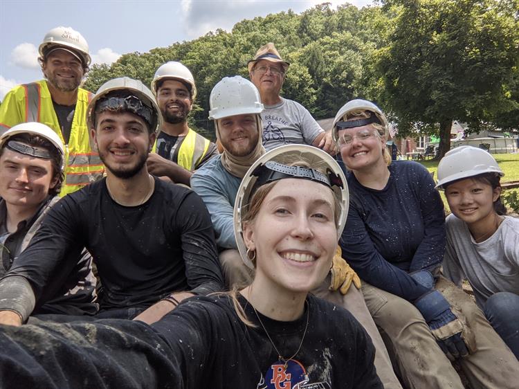 Project Manager Lauren Horvath (front) takes a group selfie on the project site.