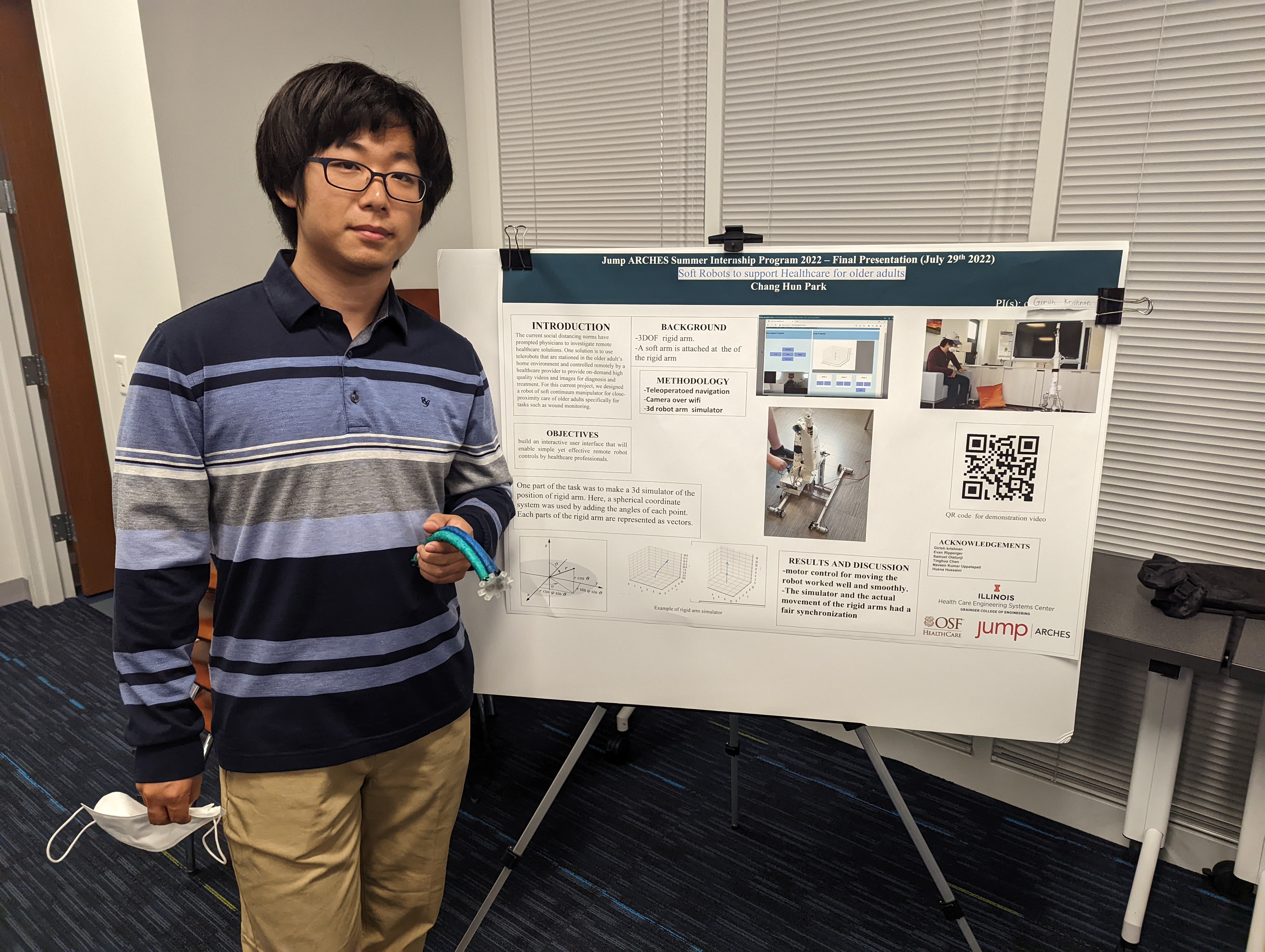 Student standing next to research poster