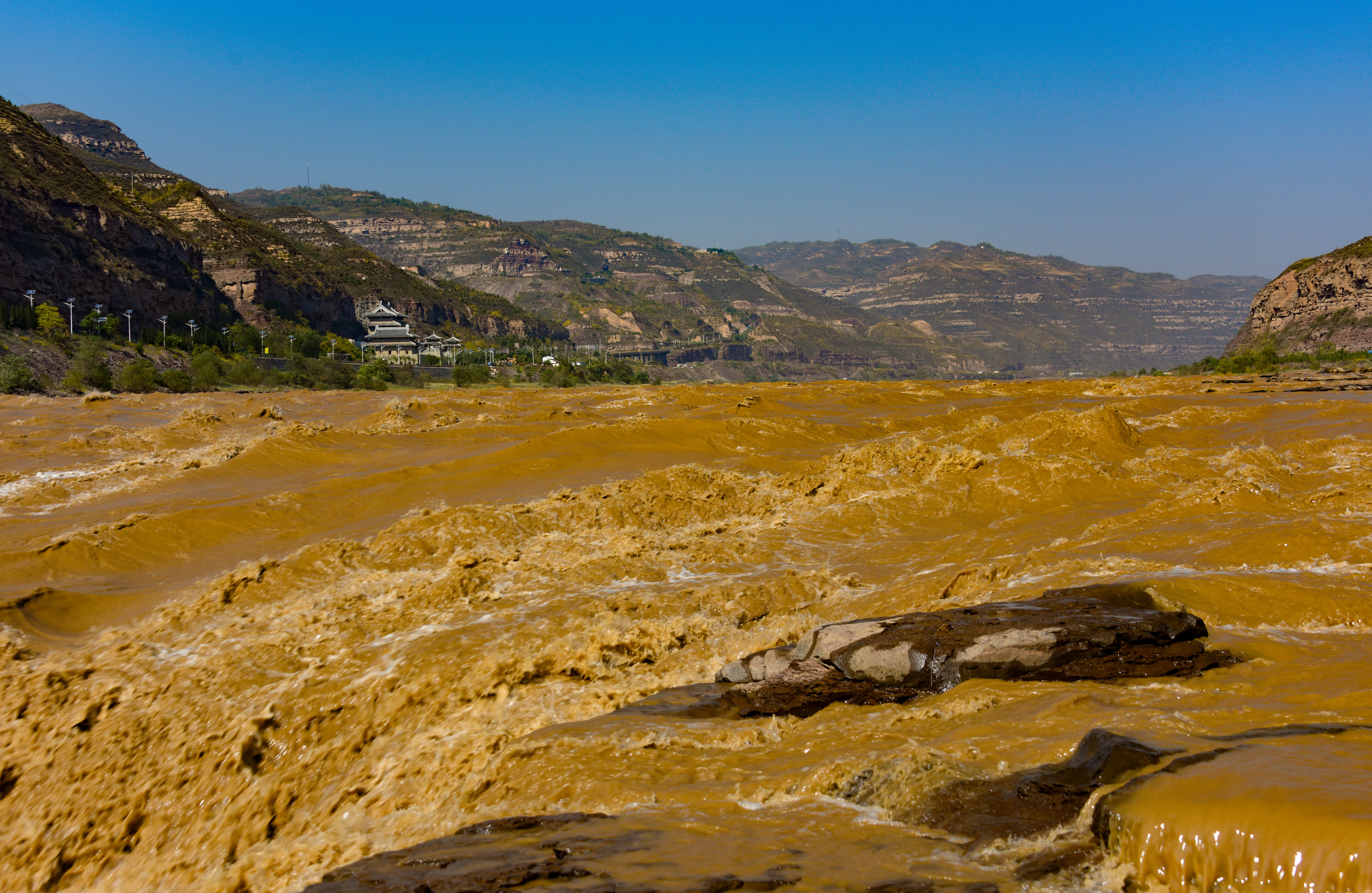 Many rivers transport appreciable quantities of silt and clay, such as the Huang He (Yellow) River, China. How do these sediment-laden flows differ from their clearwater counterparts?