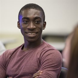 Black engineer smiling at classmate