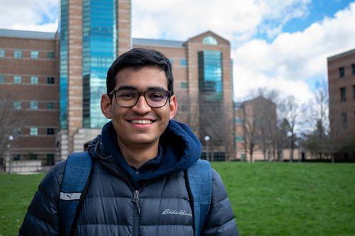 Aaryaman Patel, smiling in front of the Beckman Institute.