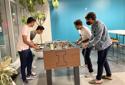 Four male students playing foosball in Lu MEB.