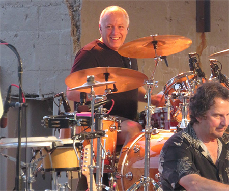 Larry Lister playing the drums on stage.