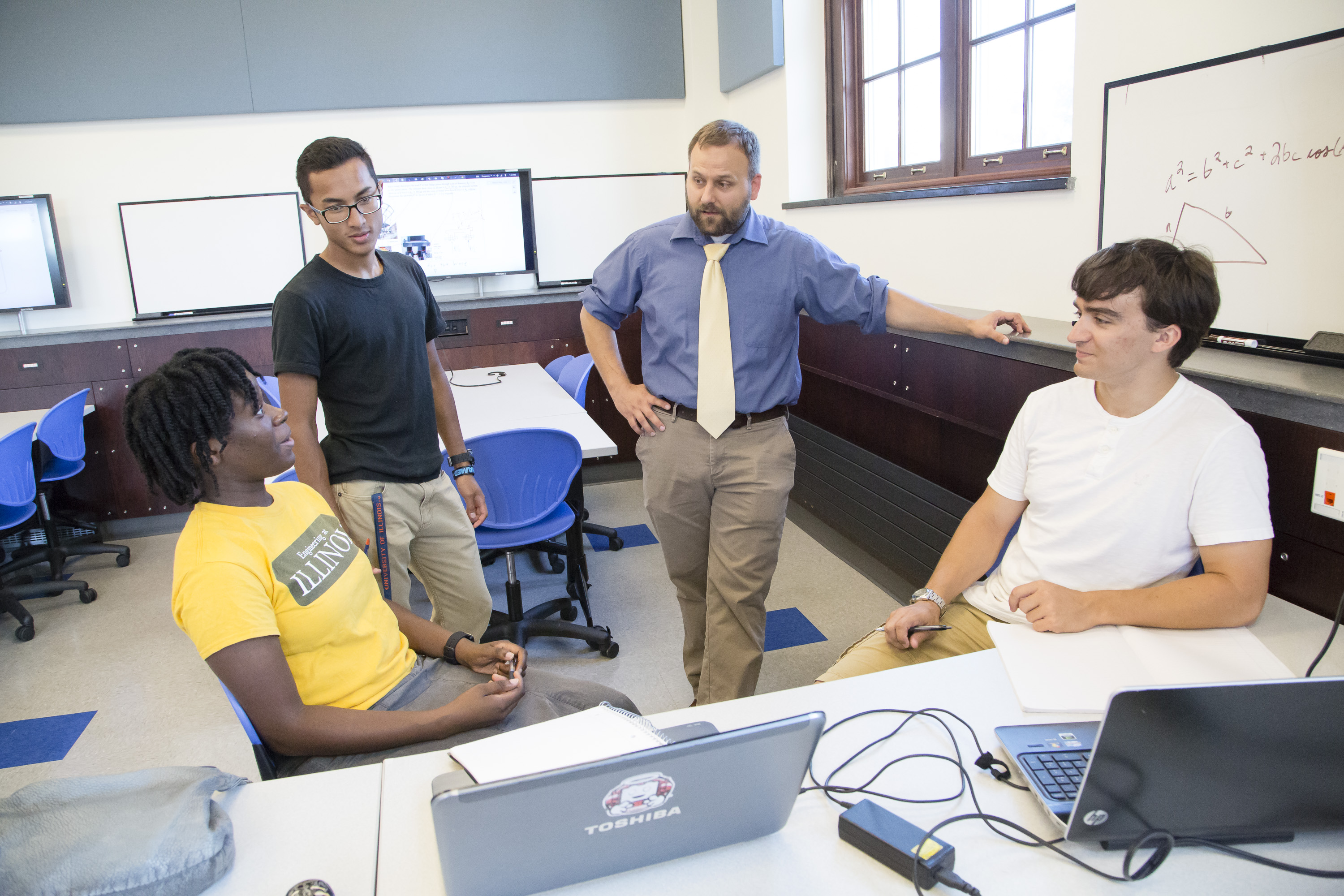 Blake Johnson teaching students around a table.