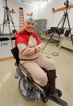 Professor Elizabeth Hsiao-Wecksler sits on her team's ballbot wheelchair device.