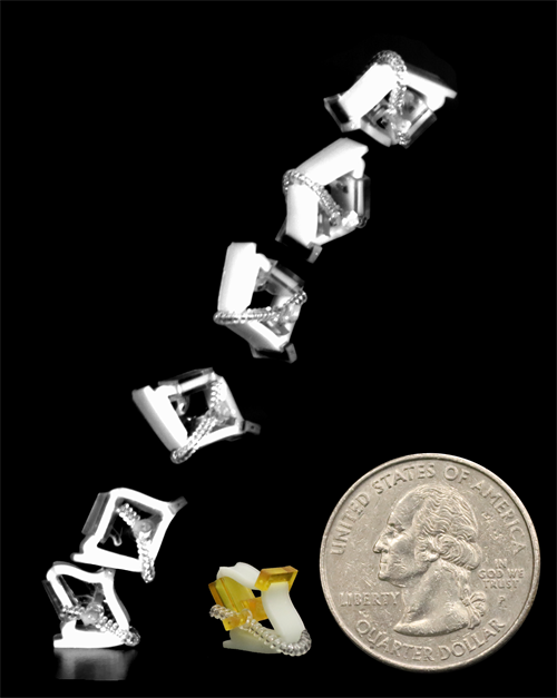 A quarter next to the tiny jumping robot, to show size. The robot is smaller than the quarter.