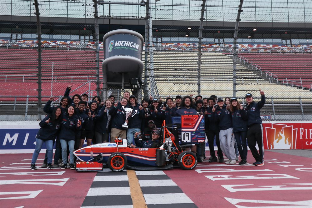 Formula SAE team with their winning car on the track