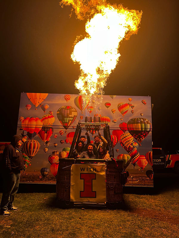 SEM group in front of a flaming hot air balloon