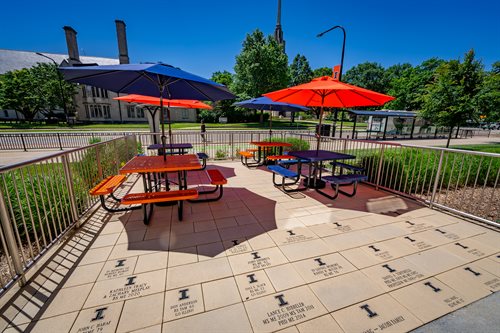 patio with engraved pavers and umbrellas and tables