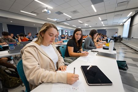 students sitting at desks in a classroom