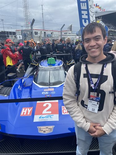 Brian Newbatt Smith standing next to racecar