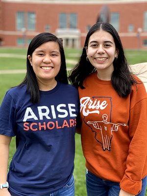 Diana Pham with another female student wearign ARISE t-shirts