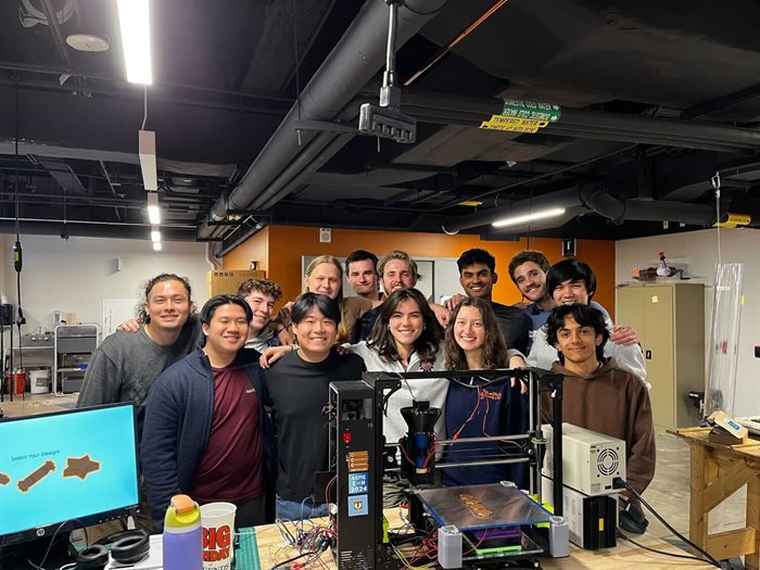 group of students with a 3D printer printing chocolate